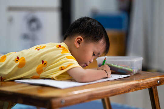 Toddler Drawing with Pencil on Paper at Home
