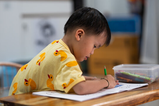 Toddler Drawing with Pencil on Paper at Home