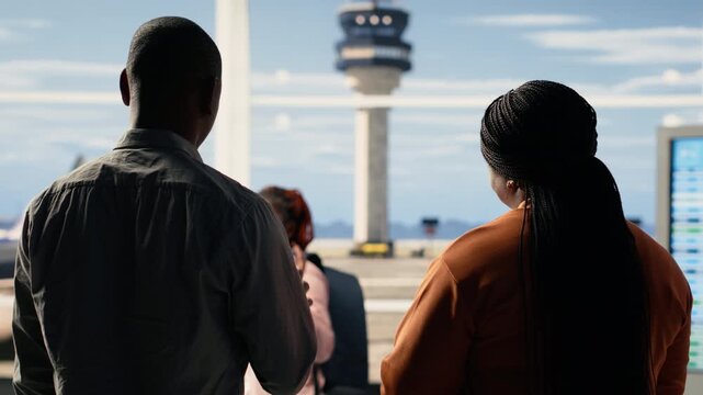 Sad yet proud parents waving goodbye during emotional send-off with their child at the airport. Teenager walking toward gate for boarding, international flight for university abroad. Farewell moment.