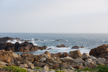 Rocky shore and coastal waves on the Atlantic Ocean before sunset in Porto, Portugal © Daria