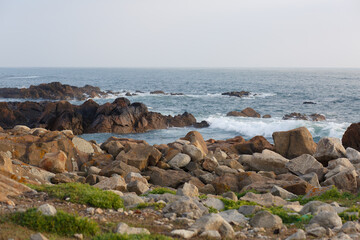 Rocky shore and coastal waves on the Atlantic Ocean before sunset in Porto, Portugal © Daria