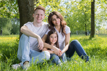 Fototapeta premium A very happy family on the green grass