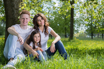Fototapeta premium A very happy family on the green grass