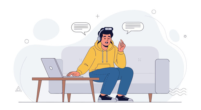 Young man with headphones on couch, working on laptop, communicating online