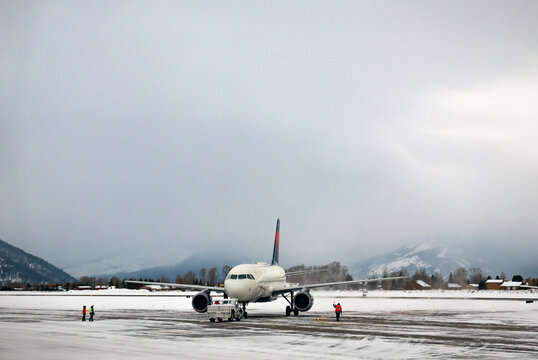 airplane at the airport in the snow in Jackson Hole, Wyoming.