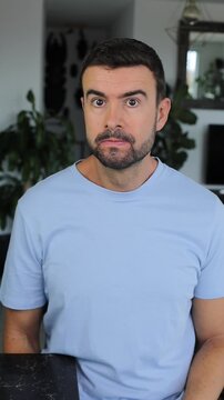 Man Looking at Camera with an Apologetic Expression and Pouting Face