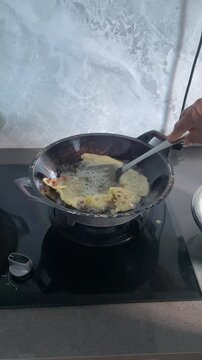 Frying Peyek Indonesian Food in Traditional Wok with Hot Oil and Crispy Texture