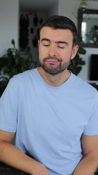 Sad man making a negative gesture, showing regret or inability
