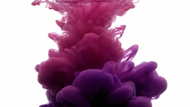 Purple and pink ink dissolving in clear water creating abstract fluid shapes for creative projects.