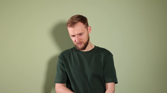 Portrait of resentful man on olive background