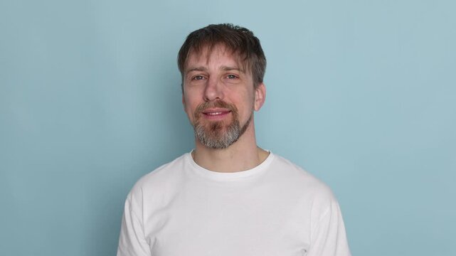 Handsome man posing on light blue background