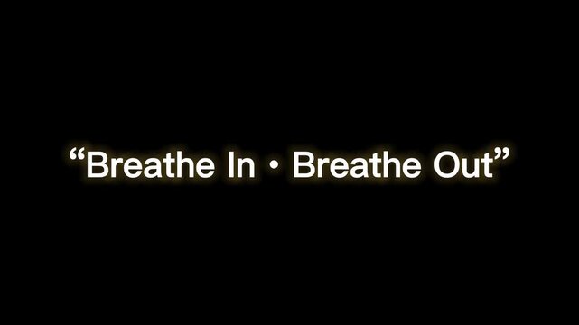 Inspirational quote on black background with golden text breathe in breathe out