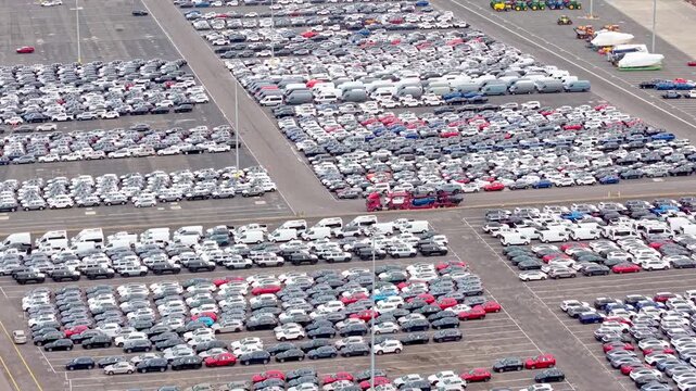 Large-scale car storage lot with rows of vehicles