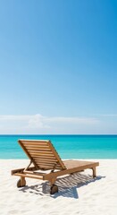 Fototapeta premium A wooden lounger sits on soft white sand looking out over the turquoise ocean under a clear blue sky during a peaceful summer afternoon, leisure, travel, outdoor