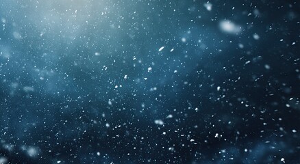 Fototapeta premium Falling snow crystals drift through a dark, moody, illuminated sky