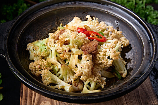 Traditional casserole dish: Spicy cauliflower and sliced pork with rice peppers