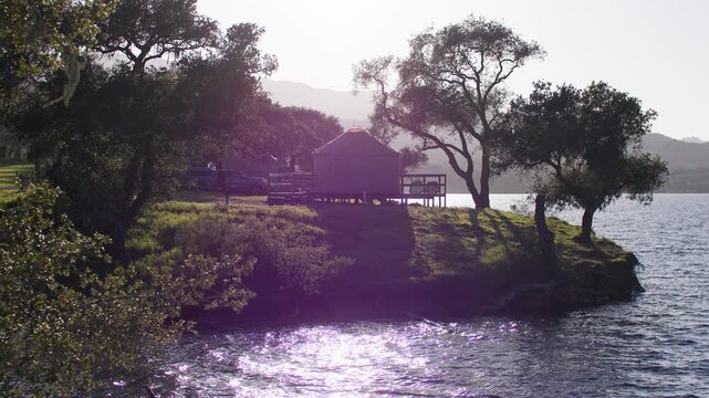 Serene lakeside cabin at Cachuma Lake, California, with trees and water