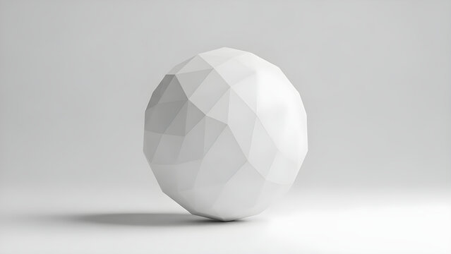 A large white polygonal sphere sits on a plain surface in a studio.