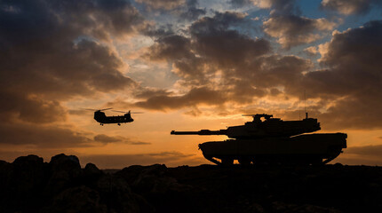 Silhouette of a powerful military tank and a transport helicopter against a dramatic sunset sky photograph. © Laura