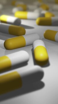 Camera Pans Across Cinematic Yellow and White Pill or Drug Capsules - Vertical.