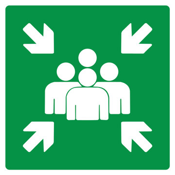 Green assembly point sign indicating a safe gathering area during evacuation to ensure safety and prevent chaos in emergencies.