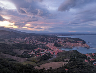 Fototapeta premium The Architecture of Collioure: Medieval Summer Palace of the Kings of Majorca the Baroque Notre-Dame-des-Anges aerial sunset view blue hour