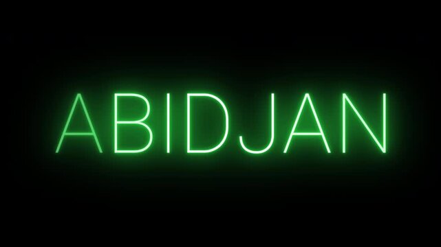 Flickering neon green glowing abidjan sign animated on black background.