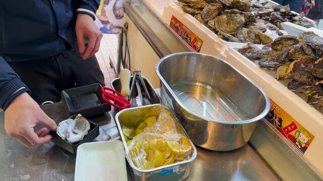 Japanese Vendor Shucking and Preparing Fresh Oysters at Tsukiji Fish Market