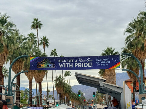 Palm Springs, California USA on November 22, 2025. A street-level view of a promotional banner for the historic Plaza Theatre in Palm Springs, California, celebrating Pride with rainbow motifs and pal