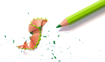 Green pencil and wooden shaving on white background.  © eza