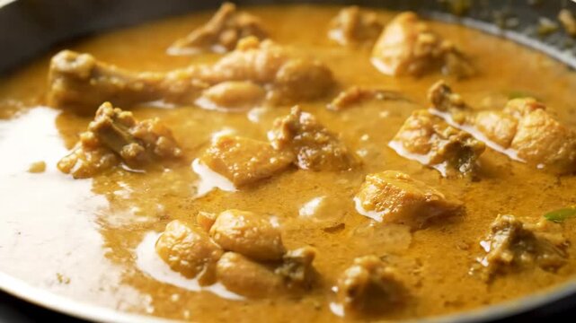Cinematic macro close-up of bangladeshi chicken jhol light curry with traditional spices