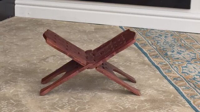 A Quran Stand on a carpet inside a mosque.