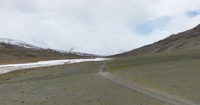 Vehicle Driving Off Road Through Tsagaan Gol Valley In Altai Mountains Of Mongolia - Drone Shot