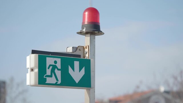 Emergency exit sign and alarm signal at building site