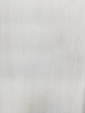 White painted wall texture with subtle vertical brush strokes. Minimalist light gray stucco background, clean plaster surface for elegant design, copy space, and professional overlays.