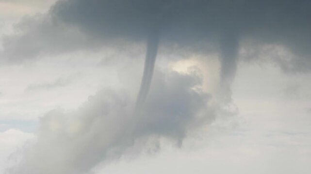 Dramatic twin waterspouts swirl amidst stormy clouds dynamic natural phenomenon footage