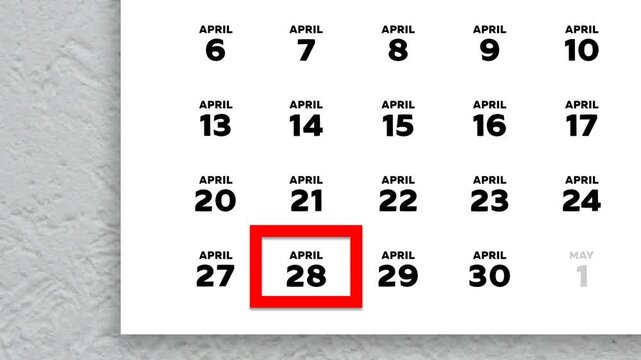 The date April 28th marked with a red cursor on the wall calendar 2026