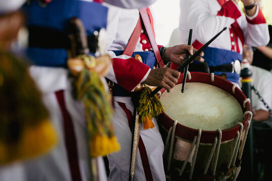 Traditional Drum Performance in Uniform During Cultural or Military Ceremony