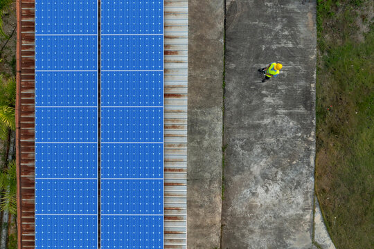 Technician using drone to inspect residential rooftop solar panels