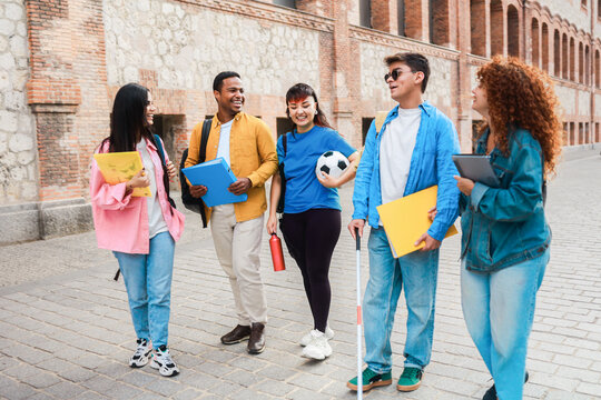 Student with disability having fun with friends outside campus university - Focus on blind guy face