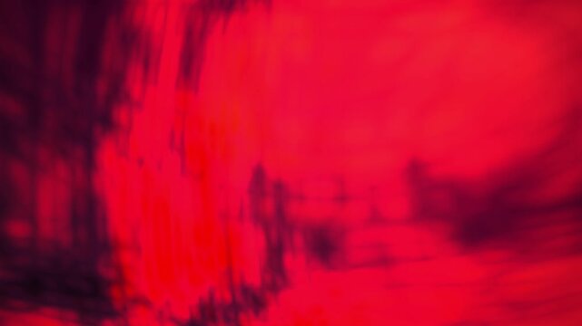 Abstract red background with dark shadows.