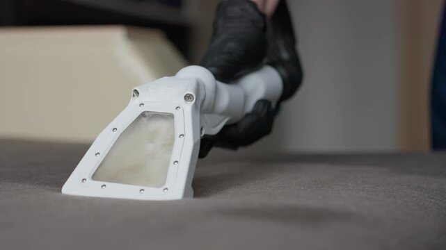 Operator Finishes Sofa Cleaning Professionally. Precise Cleaning Of Sofa With Detailed Technique. Experienced Technician Carefully Removes Stains And Smoothens Fabric For Flawless Sofa Appearance