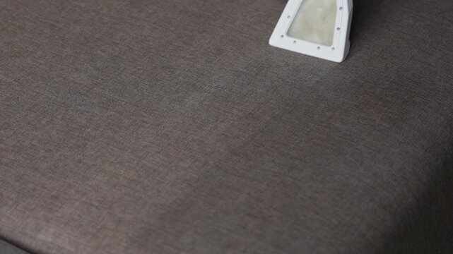 Closeup Shows Fabric Care And Texture Change. Detailed View Of Fabric Restoration After Cleaning Process. Comparison Of Treated Fabric Area With Surrounding Surface After Cleaning And Drying