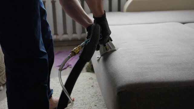 Professional Furniture Fabric Cleaning Process. Expert Methods For Deep Cleaning Upholstery Fabrics. Technician Thoroughly Cleans Cushion Surfaces Using Specialized Equipment And Techniques