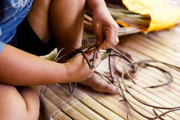 Hands of Indigenous Mangyan Woman Carefully Weaving a Traditional Basket from Bamboo Fibers in Mangyan Village, Talipanan, Puerto Galera, Oriental Mindoro, Philippines