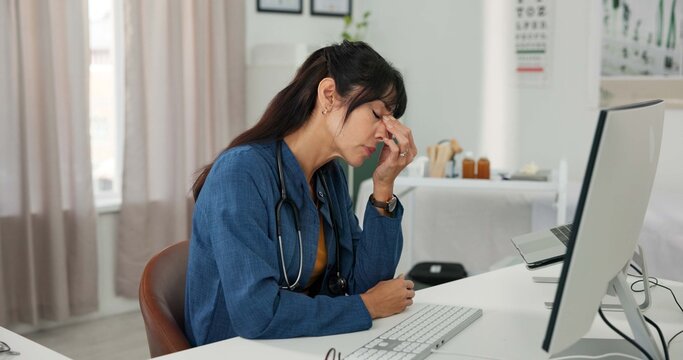 Tired, doctor and woman with computer in hospital, reflection and overworked with digital eye strain. Healthcare, fatigue and mature person with burnout, blue light exposure and overtime in clinic