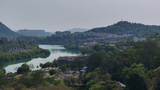 Aerial view of a winding river through a lush green valley in asia