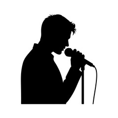 Silhouette of a man singing into a microphone on stage. © Erik
