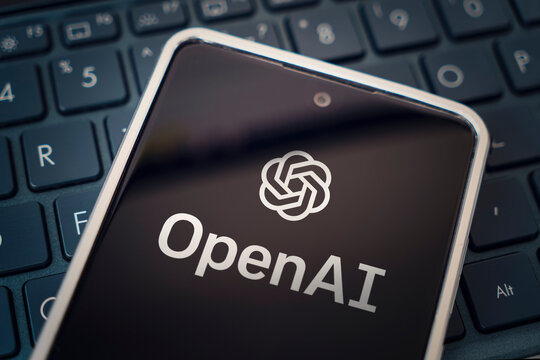 OpenAI logo seen on screen smartphone and laptop. Open AI - American company engaged in the development and licensing of machine learning-based technologies.