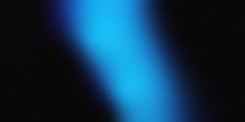 Obraz premium Blue cinematic light beam on a heavy grain black background. This sleek atmospheric texture provides excellent copy space for professional tech layouts.